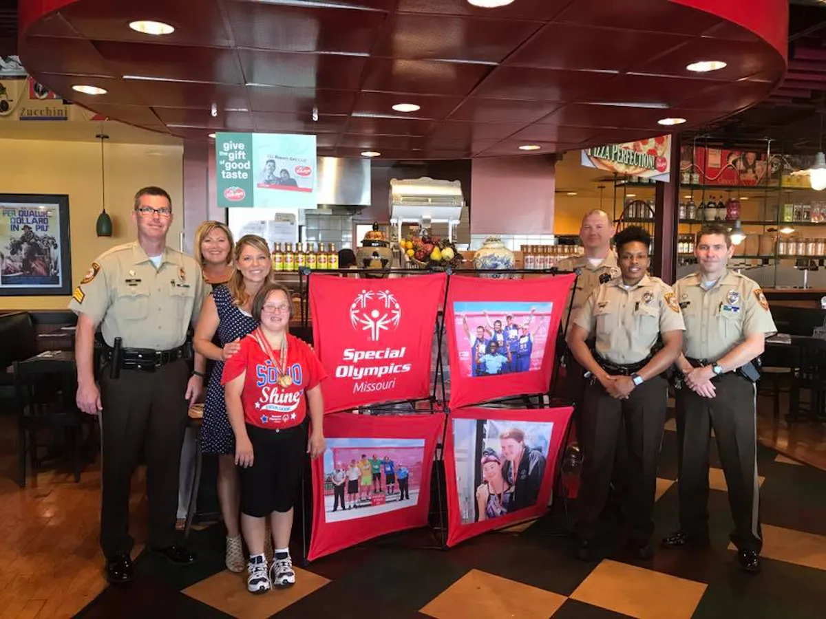 a group of people standing in front of a store